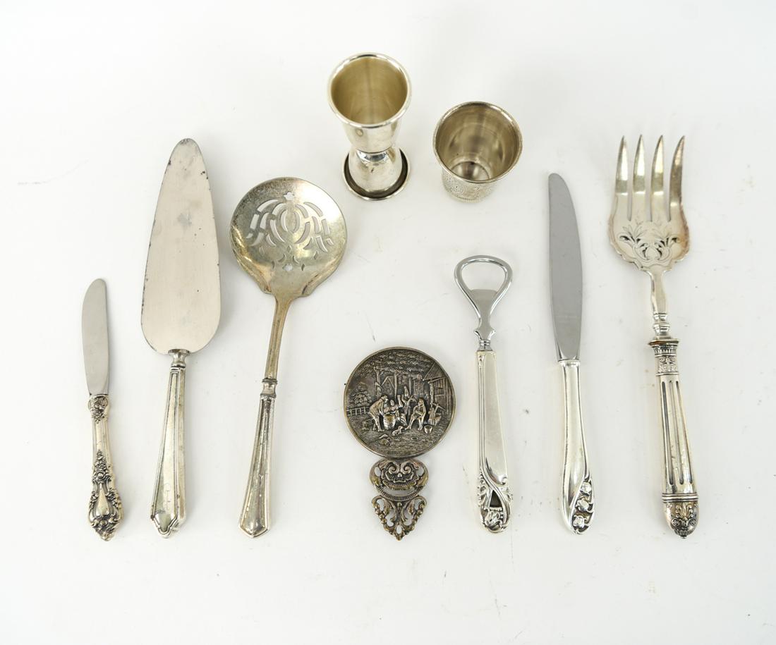 GROUPING OF STERLING SILVER ETC.: Including an Alvin sterling jigger, a sterling Kiddish cup, Danish silverplated mirror and misc sterling silver handled servingware. Dimensions: Jigger: H 4" Condition: small denting and signs of use.