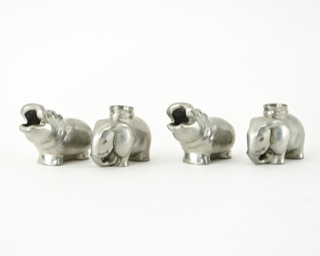 (4) JUST ANDERSEN DANISH CANDLEHOLDERS: (2) hippos and (2) elephants, candle or cigarette or pen holders. All marked "Just" in triangle and Danmark. Dimensions: H 1.25" x W 1.5" Condition: Showing signs of use, including light scratching.