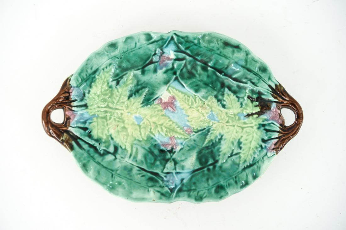 TWO HANDLE MAJOLICA PLATE: Dimensions: H 2" X W 12" D 8" Condition: white spot is a defect in the making where it is missing glaze. Very minor signs of age otherwise