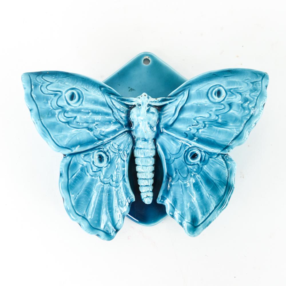 CLEMENT MASSIER FRENCH MAJOICA BUTTERFLY POCKET: A figural turquoise color, butterfly wall pocket. With impressed Clement Massier marking under glaze. Dimensions: H 8" x W 9" x D 2.5" Condition: small, pencil tip size, defect in the making near the