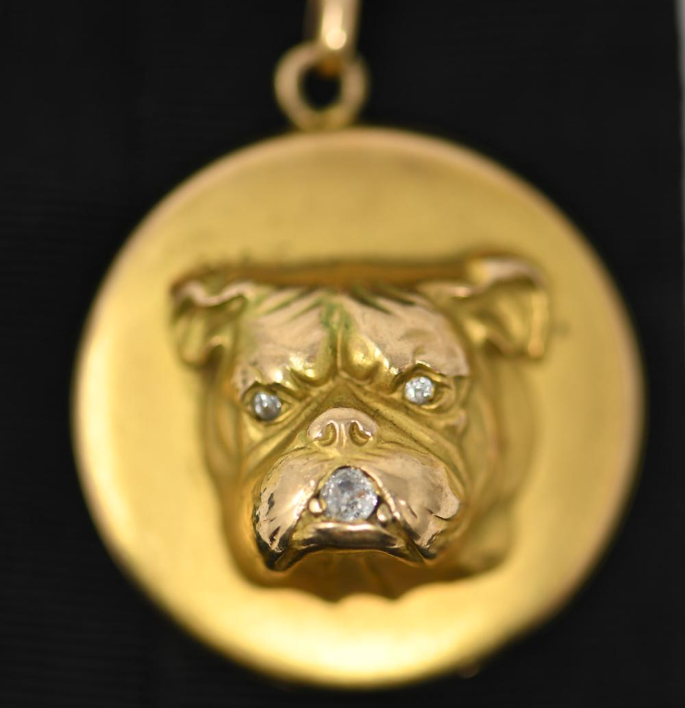 14K GOLD & DIAMOND BULLDOG LOCKET FOB: Diamond eyes and mouth. Hallmarked 14k and R and hexagon. On antique ribbon. Dimensions: (Pendant) Dia. 1.25" x L 2" Weight: (Overall) 7 dwt Condition: Showing normal signs of age including tarnishing
