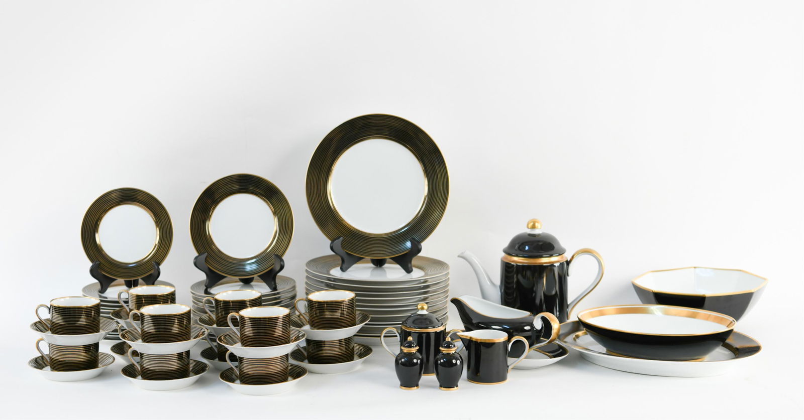 FITZ & FLOYD "RONDELLE" PORCELAIN SERVICE FOR (12): c. 1980s. Including: (12) teacups, teapot, serving platter, oval serving bowl, octagon serving bowl, gravy and underplate, salt and pepper shakers, (12) saucers, creamer, sugar, (12) 6.5" plates, (12)