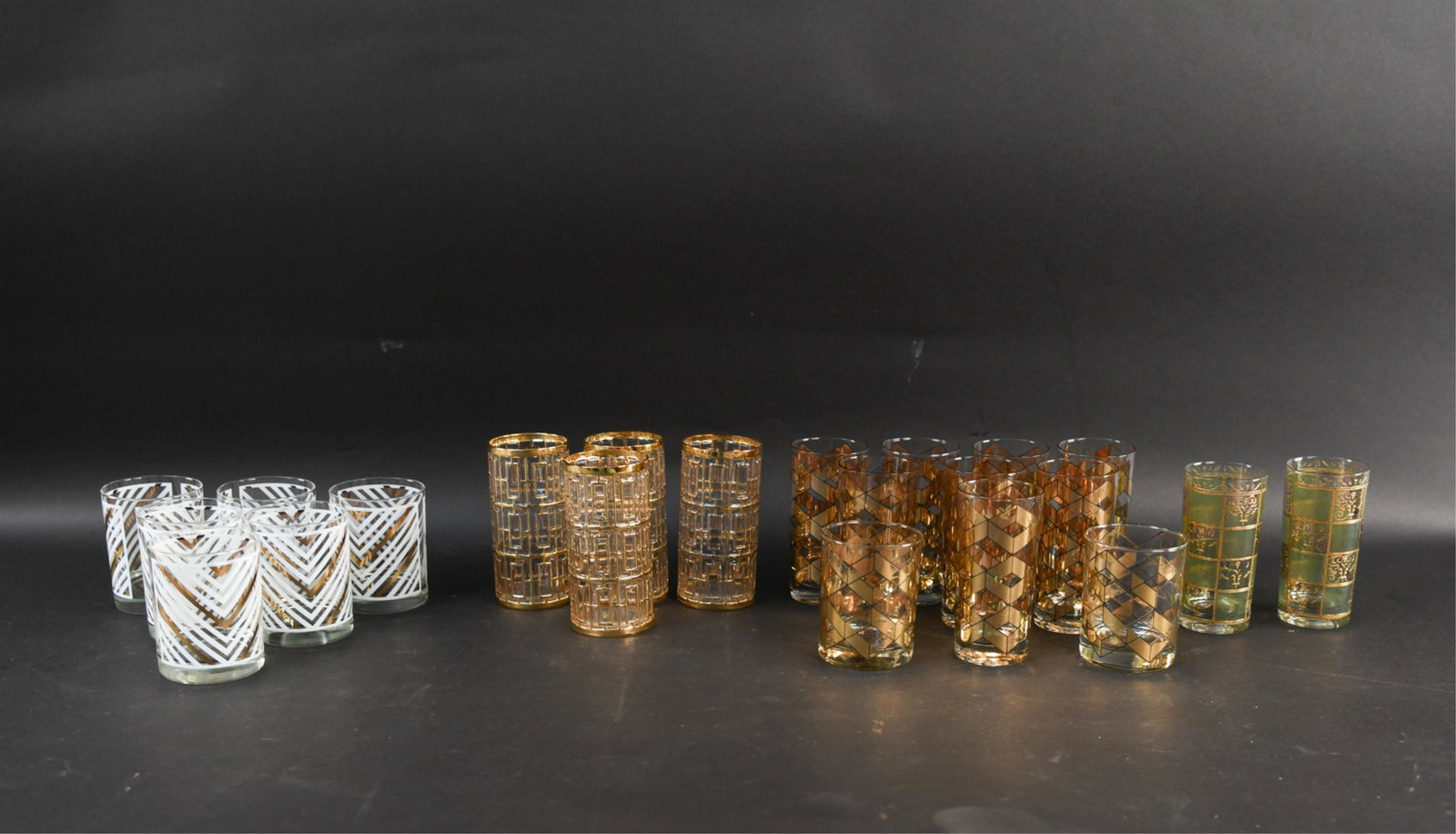1950S BARWARE GLASSES: Four patterns. Dimensions: (Tallest) H 5.75" x Dia. 2.75" Condition: Showing signs of age and use including wear to surface decorations.