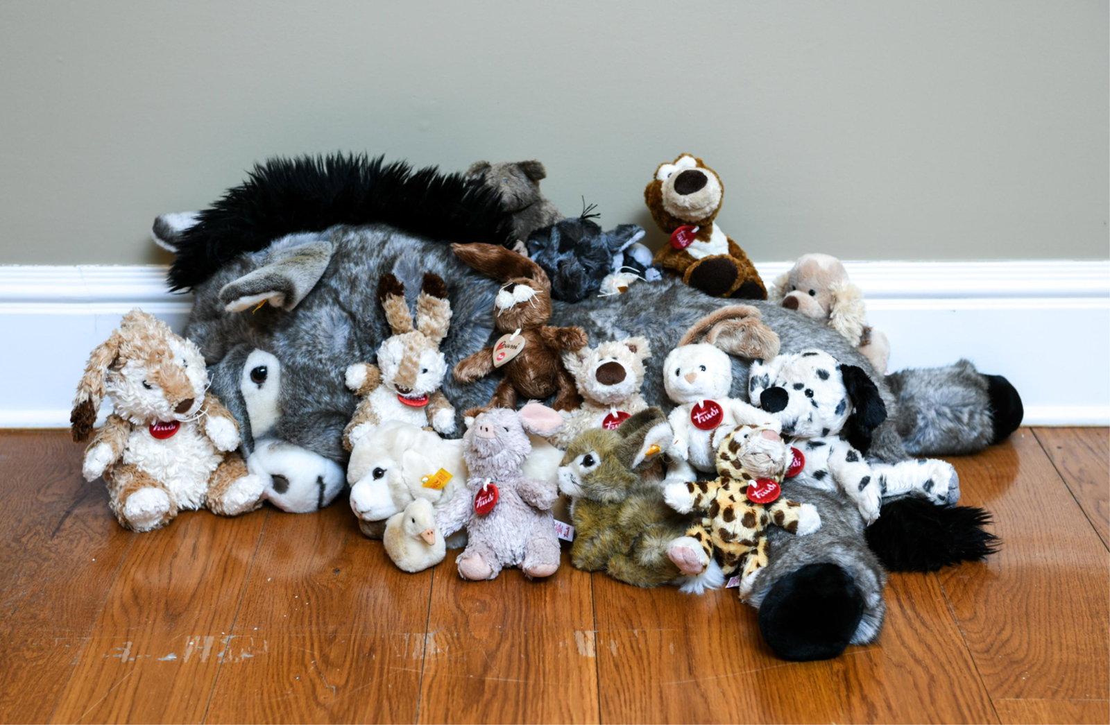 GROUPING OF STEIFF AND TRUDI STUFFED ANIMALS: Lamb is not included Dimensions: (Largest) H 19" x W 26" x D 14" Condition: Overall light wear consistent with handling.