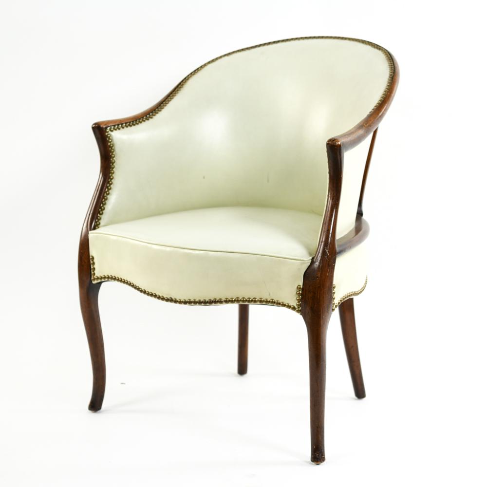 GEORGE III STYLE MAHOGANY & LEATHER BERGERE CHAIR: Saber leg style. Dimension: H 34" x W 25" x D 24" x SH 17" Condition: Few stains and scuffs to leather. Scratches and nicks to frame.