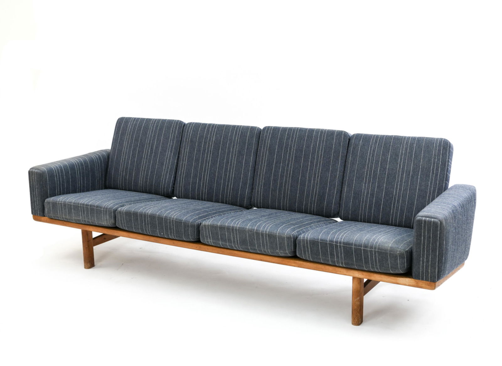 HANS WEGNER GETAMA 4-SEATER SOFA: Marked; Getama / Hans Wegner Dimensions: H 30" x W 92" x D 30" x SH 15.5" Condition: Areas of wear to upholstery. Small nicks and staining to wood. Overall wear from age and use. H153