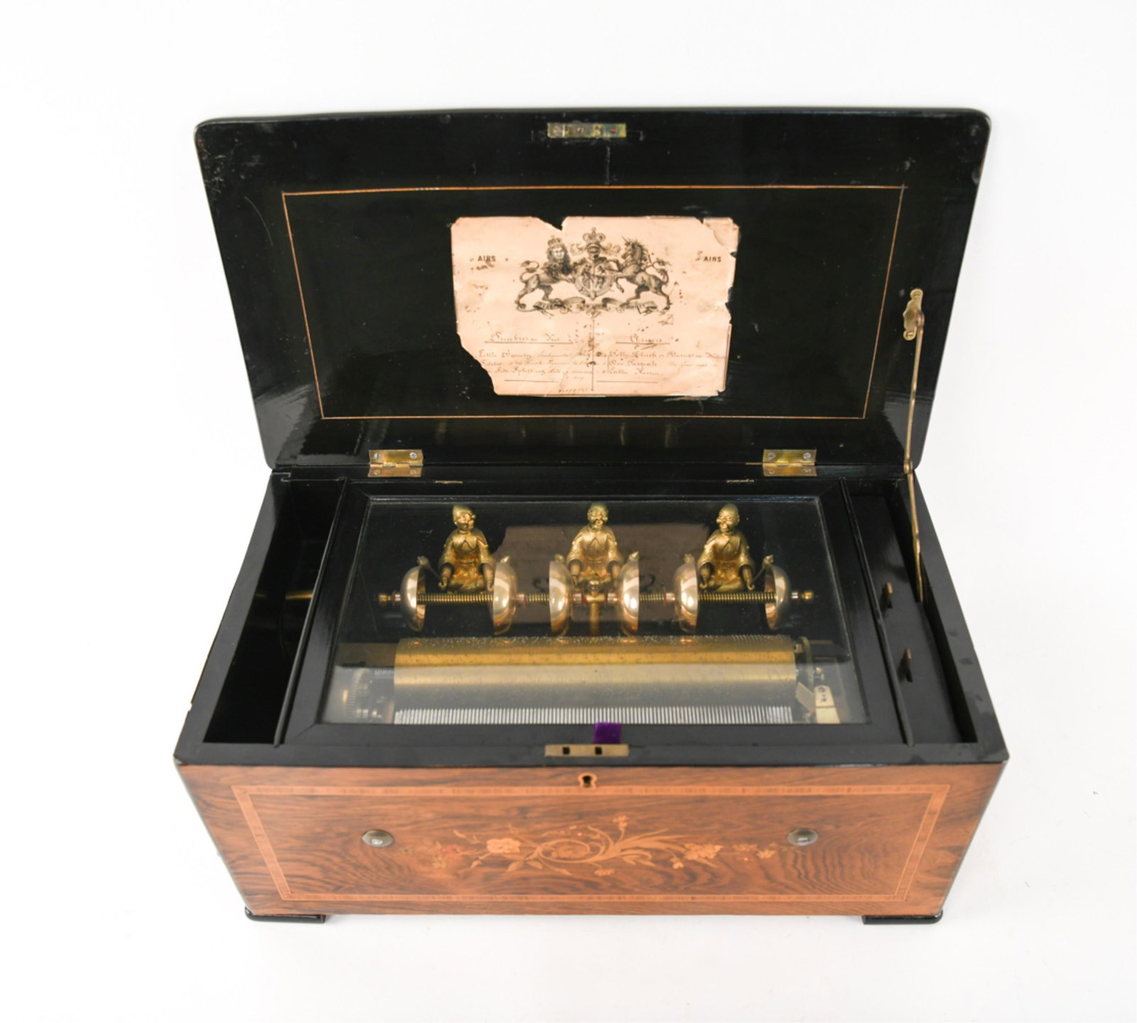 ANTIQUE SWISS SIX BELLS MUSIC BOX: Cylinder music box of inlaid rosewood. With Chinese figures and six bells. Manufacturer not noted, but label with coat of arms of prince of Wales. Reference number 39179/741. Dimensions: H 9" x W 20.5
