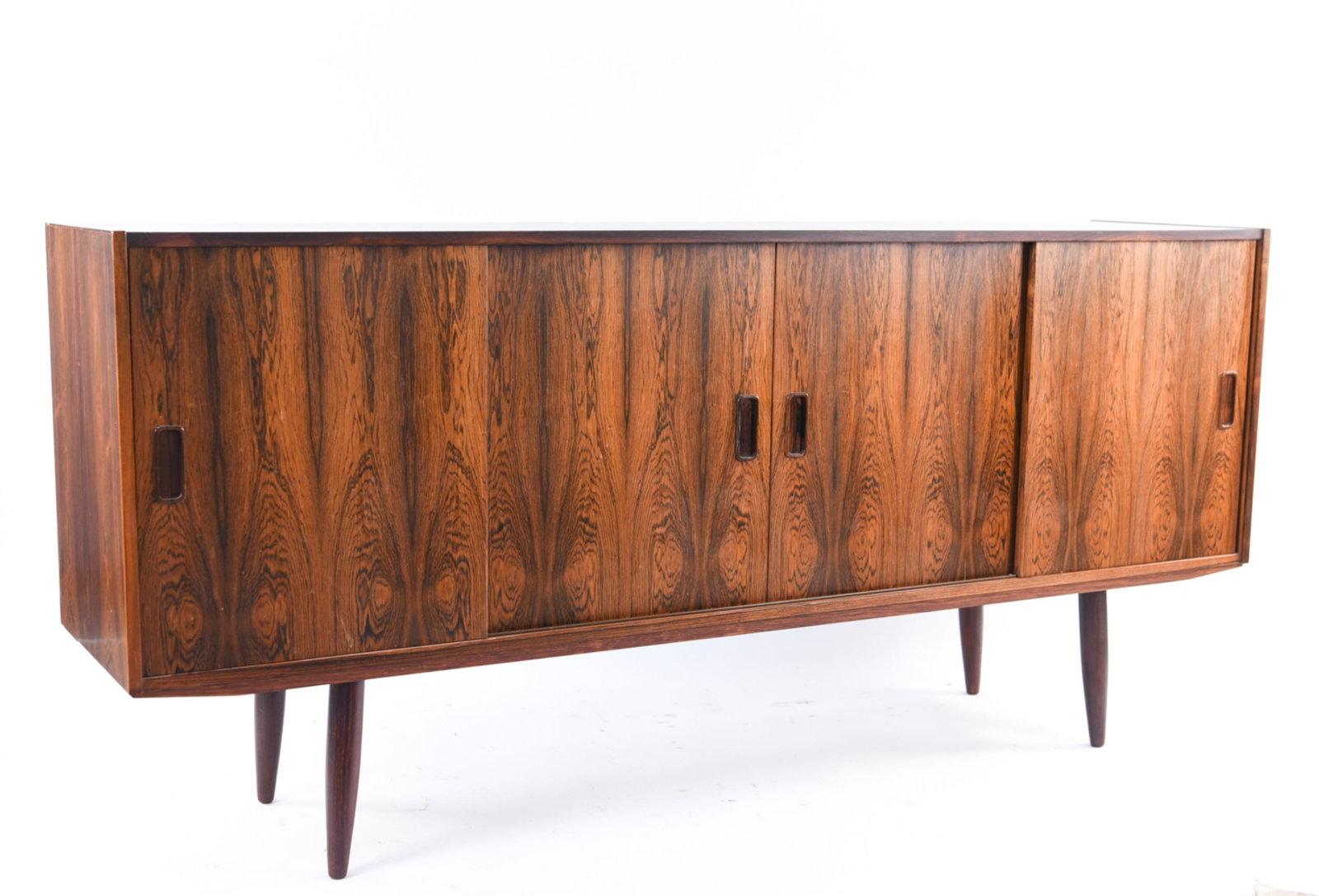 ROSEWOOD DANISH WESTERGAARDS SILKEBORG SIDEBOARD: Rosewood. Dimensions: H 34" x W 75" x D 16.5" Condition: Wear consistent with age and use. Minor fading. Top veneer has been replaced with a modern mat black finish. Paint marks to back. E012