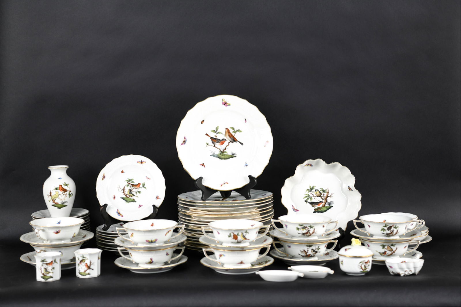 EXTENSIVE HEREND PORCELAIN SERVICE: Birds and insects with gold rims. Including four sizes of plates, bowls, serving dishes, condiments, etc. Dimensions: (Largest plate) Dia. 10.25" Condition: Incomplete set. Few scattered chips.