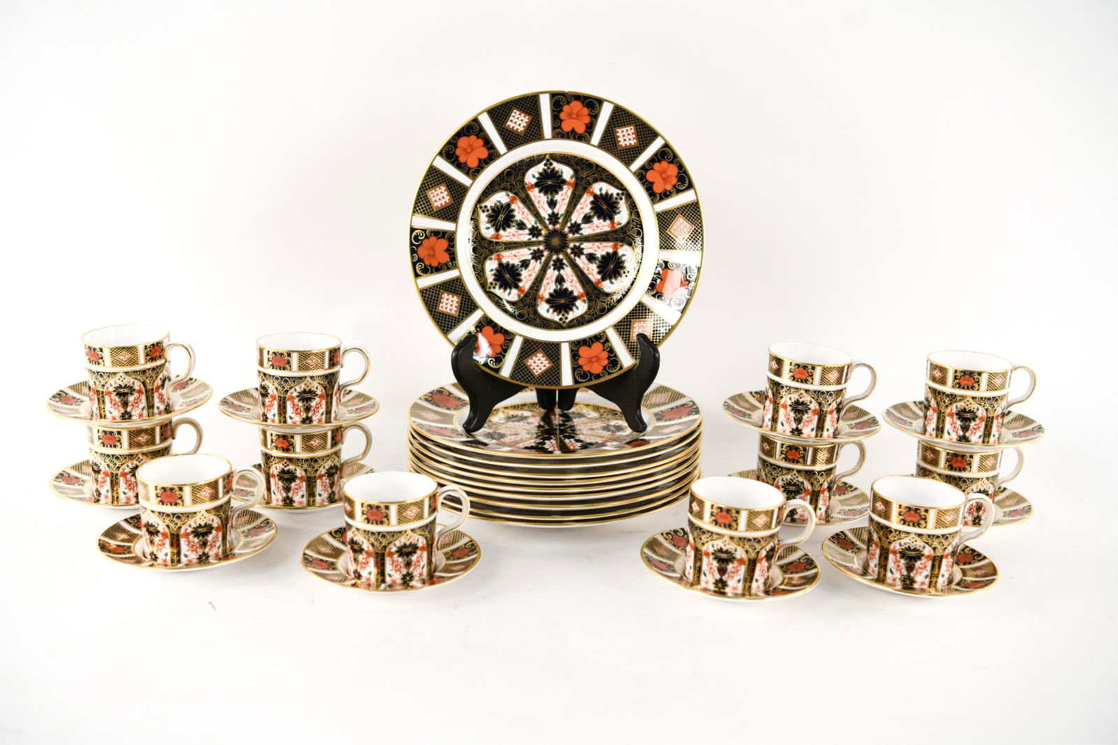 ROYAL CROWN DERBY PORCELAIN DESSERT SERVICE: Marked underneath. Old Imari pattern. Fine porcelain dessert set including: (10) plates, (12) cups, and (12) saucers. Dimensions: (Plate) Dia. 8.5" Condition: One plate with rim chip. Chip to one cup.