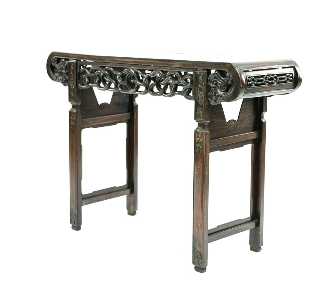 EARLY 20TH C. CHINESE CARVED ALTAR TABLE: Carved, decorated "console table." Metal fittings at bottom. Dimensions: H 32.75" x W 44" x D 15.5" Condition: Some nicks, dings, and small repairs. Including a small break.