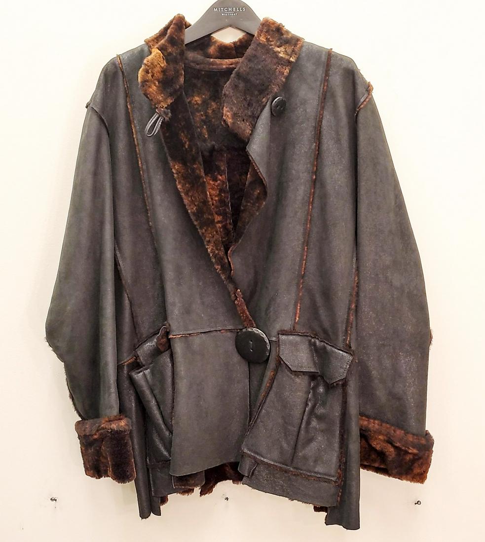 REVERSIBLE FUR AND GREEN LEATHER JACKET: No tag with size or maker. Interesting multi-tone fur. Dimensions: L 27", (Armpit to armpit) 24", Sleeve 24" Condition: Showing light signs of use.