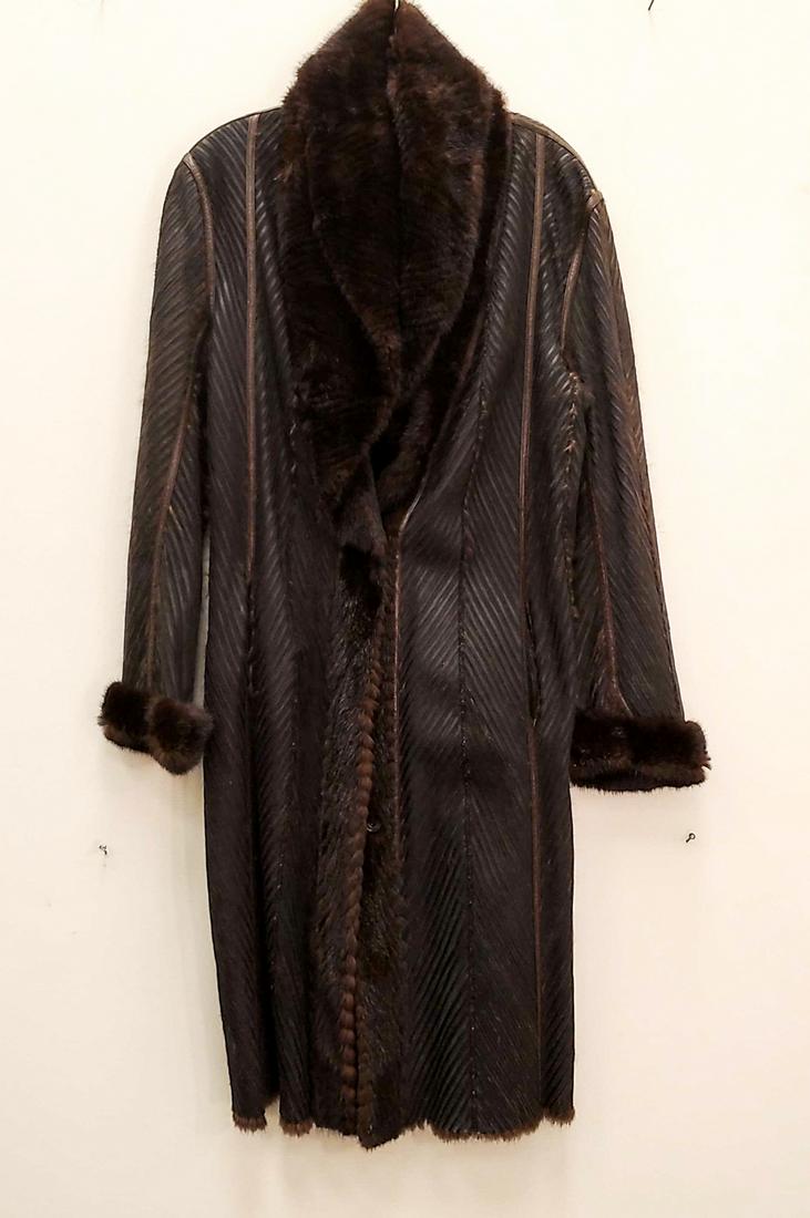 GUILIANA TESO FUR & LEATHER COAT: Reversible with chevron pattern sheared mink lining and textured black leather. Dimensions: L 42", Armpit to armpit 23", Sleeve 24" Condition: Lightly used.