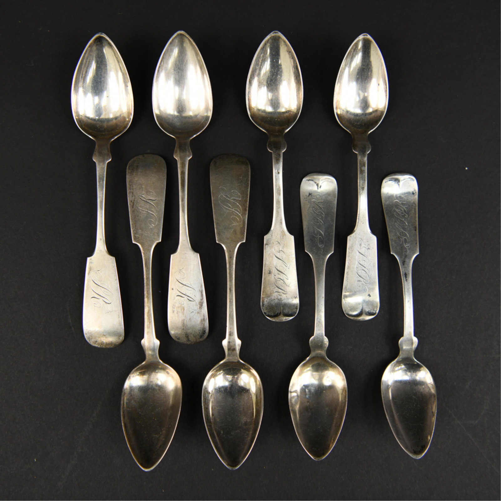 AMERICAN COIN SILVER TEA SPOONS: (4) fiddle back by H.G. Bradley, Mantua, c. 1830. (4) New York mid-19th century, initials PR. Dimensions: (Longer) L 6.25" Weight: (Total) 3.455 ozt Condition: Wear commensurate with age.