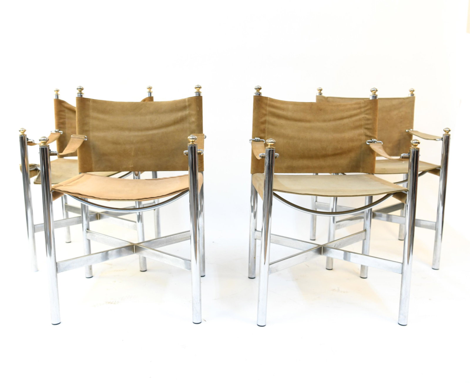 (4) CHROME AND SUEDE SAFARI SLING CHAIRS: Sections for re upholstery included. Dimensions: H 32.25" x W 20.25" x D 18.5" S.H. 17.75" Condition: Fading, stains and rips to fabric. Some pitting and discoloration to chrome.
