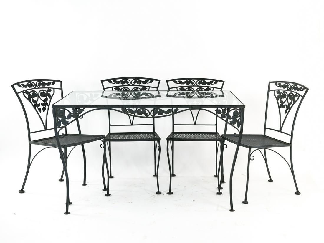 OUTDOOR WROUGHT IRON TABLE AND CHAIRS: Table and four chairs. Dimensions: (Table) H 29.5" x W 48.5" x D 30.5" Condition: Wear consistent with outdoor use including some paint loss and minor surface rust.