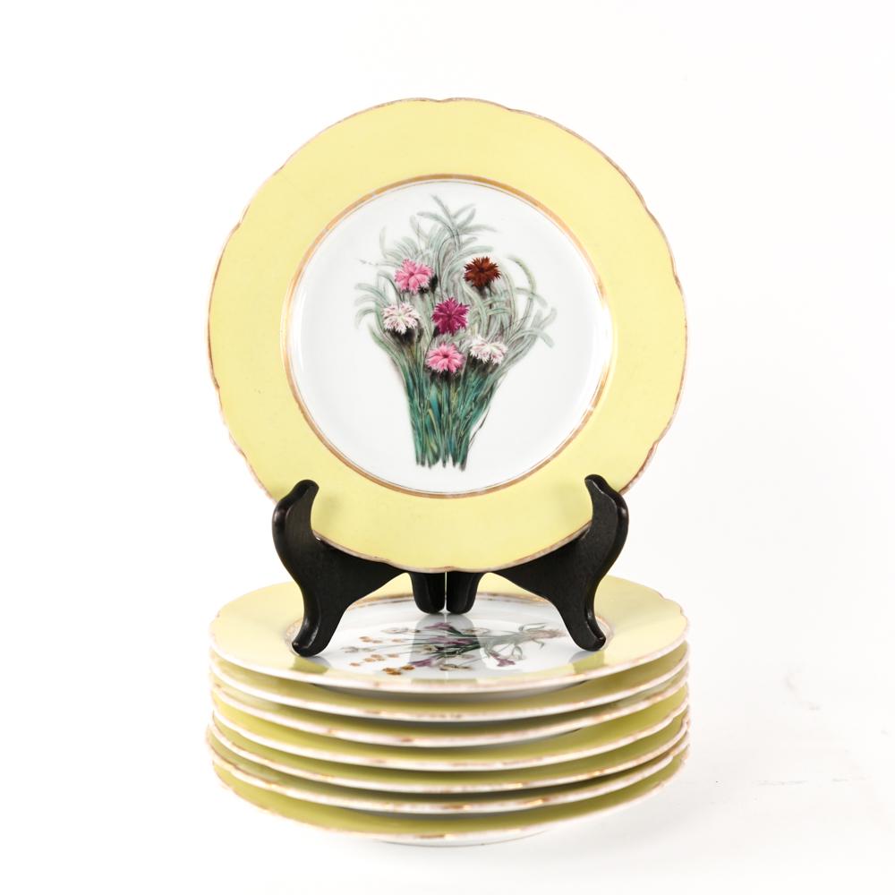 (8) FISCHER & MIEG HAND PAINTED PORCELAIN PLATES: (8) plates with botanical scenes. Yellow and gold rims. With impressed F&M mark. Dimensions: Dia. 7.75" Condition: Rubbing to gold. One with hairline.