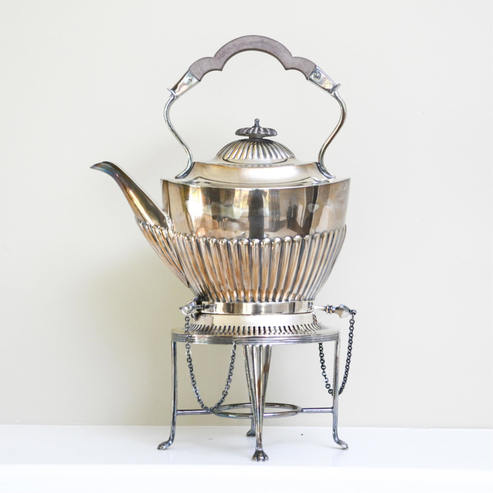 ANTIQUE SHEFFIELD PLATE TEAPOT & STAND: Pot marked underneath. Stand unmarked. Classical Georgian design with hinge locks and wood handle. Dimensions: (On stand) H 14" x W 8.5" x D 4.5" Condition: Lid handle loose. Some tarnish.