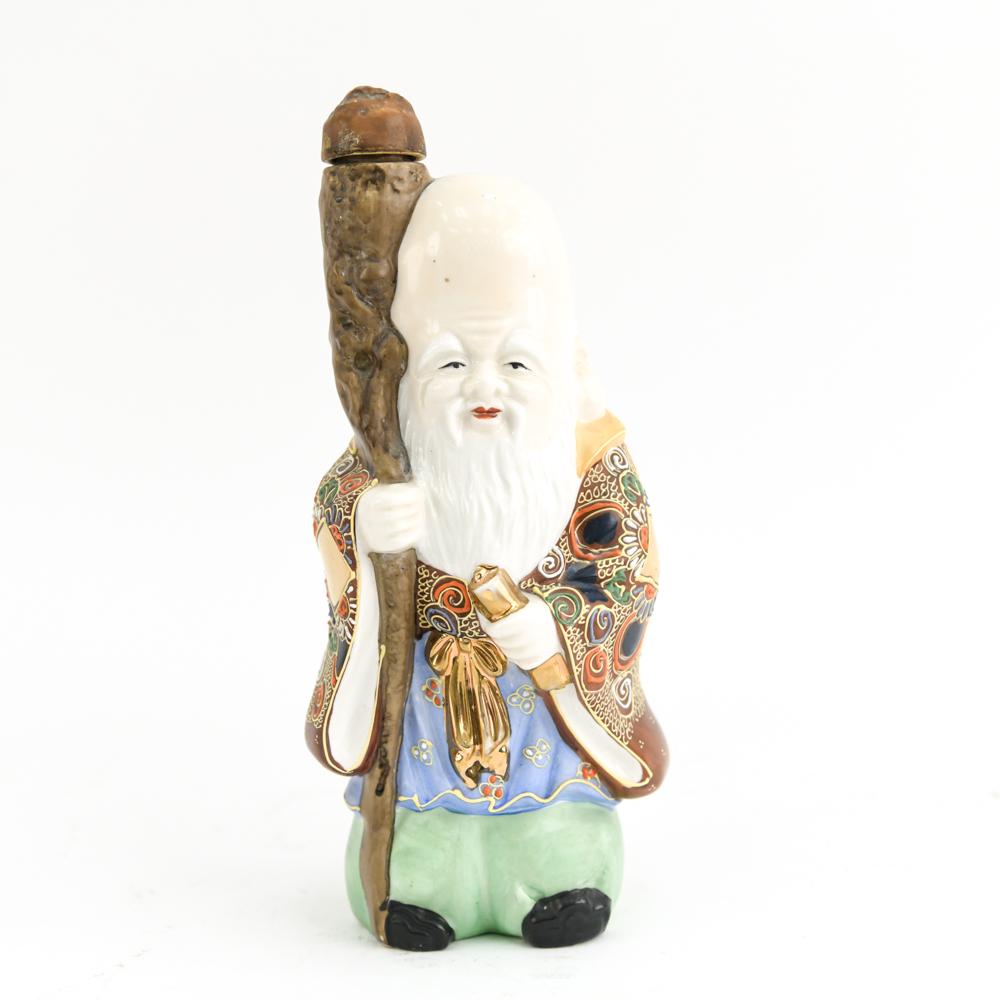 MODERN MORIAGE DECANTER: Marked "made in Japan" on bottom. Painted and gilded porcelain. Dimensions: H 10.5" x W 4.5" x D 3.75" Condition: Loss to cork stopper. Wear consistent with handling.