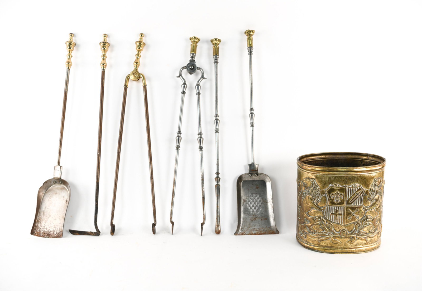 GROUPING OF FIREPLACE TOOLS & BRASS BUCKET: (7) pieces. Two different sets and bucket. Dimensions: (Longer tongs) L 29.5" x W 3" x D 1.25" Condition: Showing signs of age and use. Some tarnishing, finish loss.