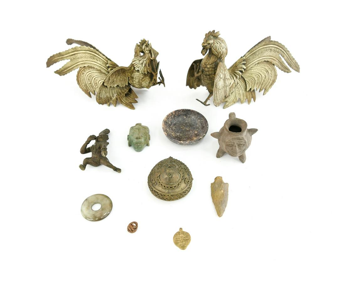 MISC. ODDITIES: Includes two Asian brass fighting roosters, Chinese jade disc, Chinese soapstone bowl, Indian brass baby Krishna, couple Pre-Columbian reproductions, etc. Dimensions: (Rooster) H 7" x W 12" x D 5" Con