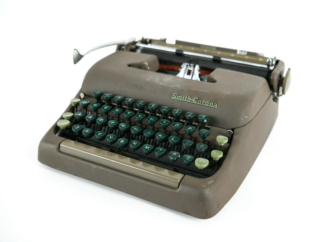 VINTAGE CORONA SMITH TYPEWRITER: Dimensions: (Typewriter) H 4.5" x W 12.5" x D 12" Condition: Not tested. Wear consistent with age and use.