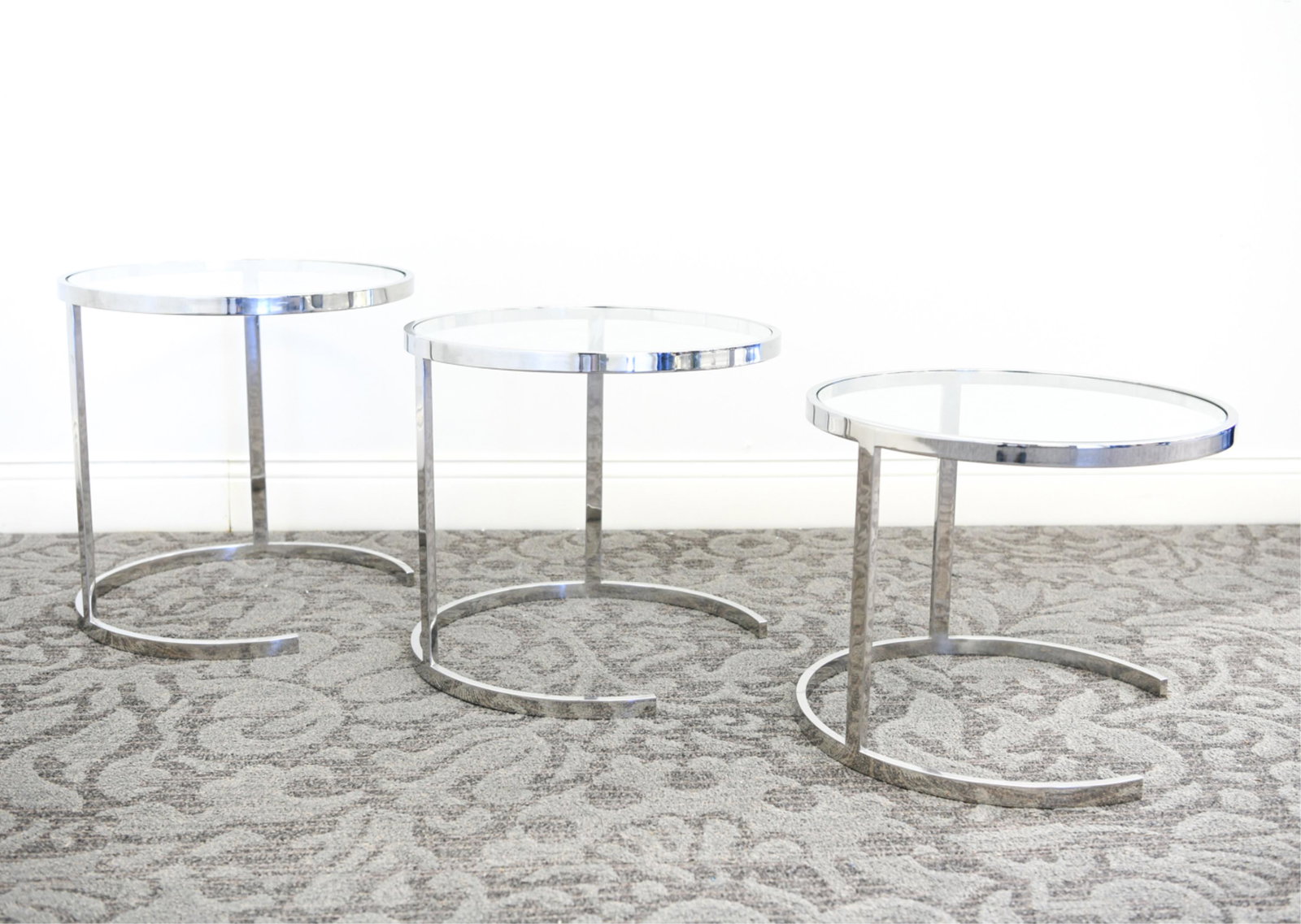 ATTR. KIPP STEWART FOR DIRECTIONAL NESTING TABLES: STEEL AND GLASS SIDE TABLES Dimensions: (Nested) H 20" x Dia 20.5" Condition: Showing very light signs of use.