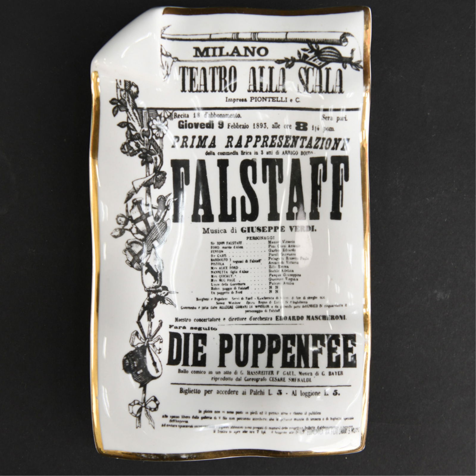 PIERO FORNASETTI TROMPE L'OEIL CERAMIC: Porcelain dish or ash tray. Dimensions: H 1.25 in. x W 5.5 in. x D 8.5 in. Condition: Minor losses to gold painted trim.