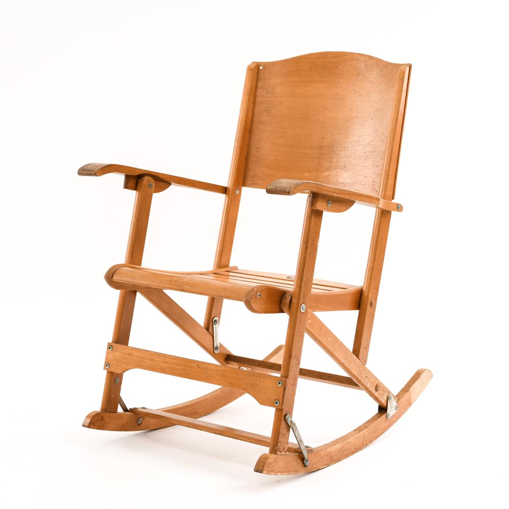 CLEMENT MFG. MODEL #218 COLAPSIBLE ROCKING CHAIR: Mfg. decal on top of seat, stamped under seat. Dimensions: H 34" x W 22.75" x D 28" x SH 16" Condition: Showing overall light wear consistent with age and use. Holes drilled into top corners of seat r