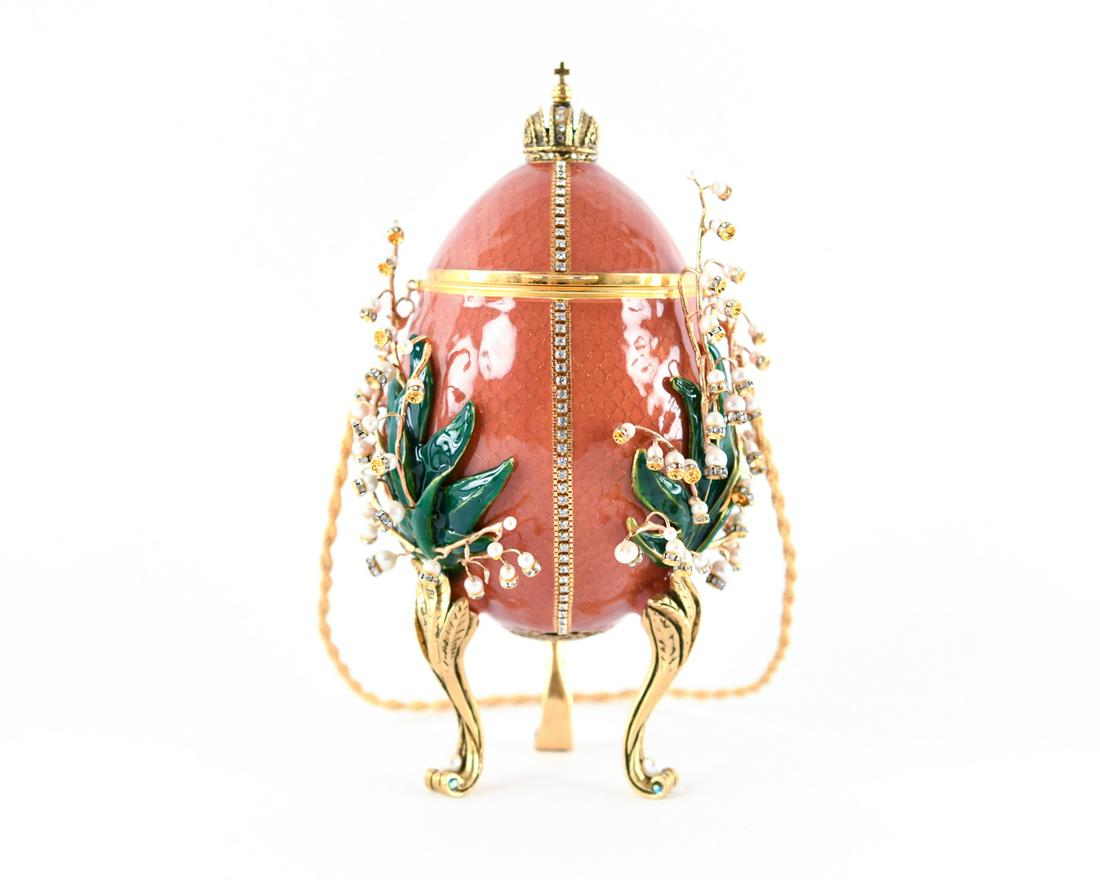 VIVIAN ALEXANDER "LILIES OF THE VALLEY" FABERGE: Recreated Faberge egg for the Forbes Collection. Enamel, Chinese pearls, Austrian crystals. Dimensions: H 9" x W 4.5" x D 4.5" Condition: 4 missing pearl flowers.