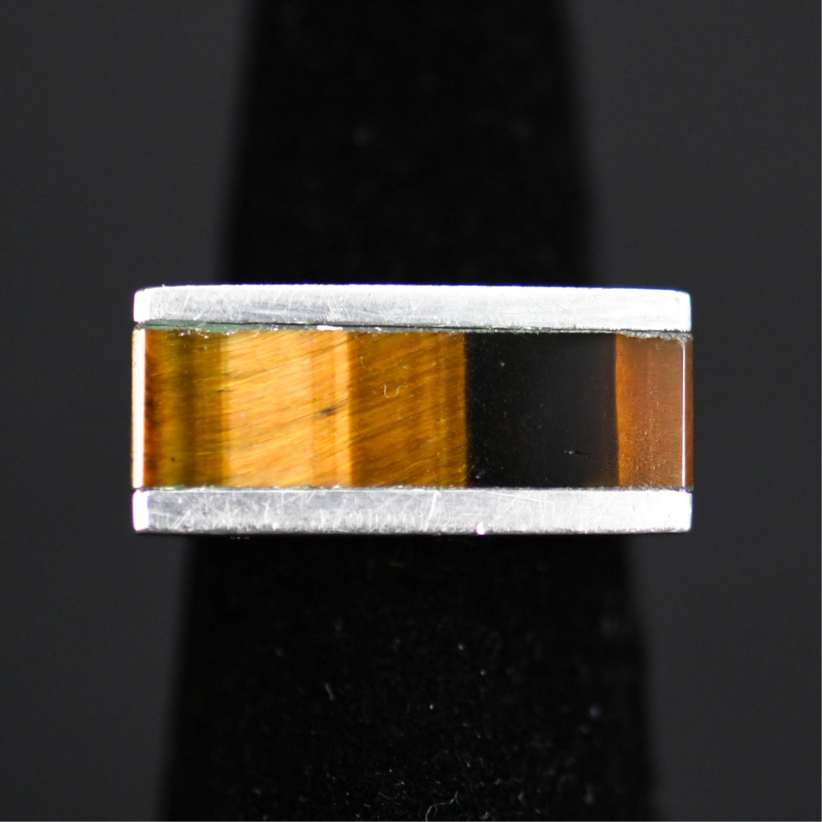 LADIES TIGERS EYE & STERLING SILVER MODERNIST RING: Hallmarked sterling. Dimensions: Face: 1" Ring Size: 6 Condition: Showing normal signs of use and age.