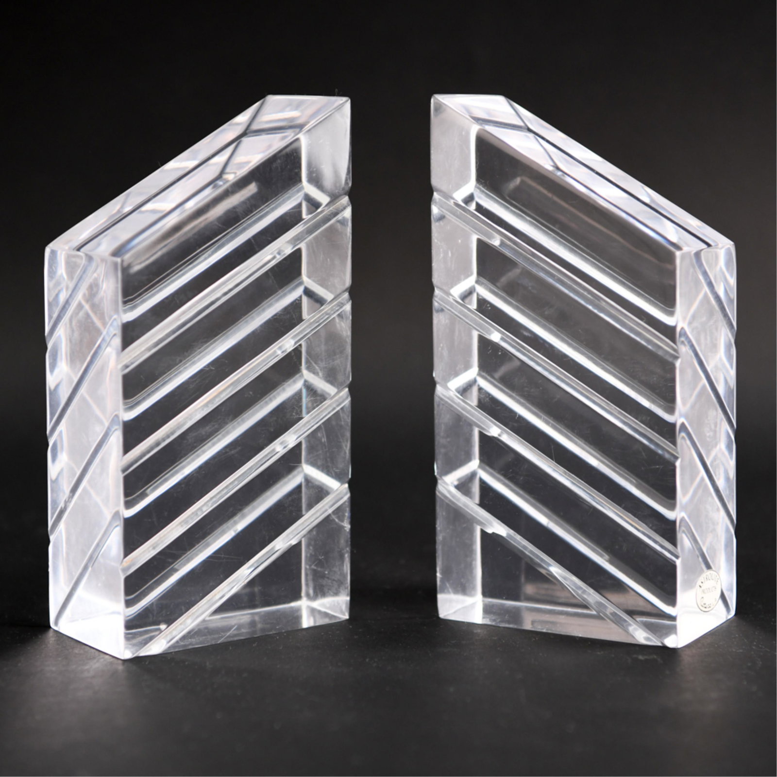 MID-CENTURY ASTROLITE LUCITE BOOKENDS: With foil Astrolite label. Dimensions: H 8" x W 4" x D 2.5" Condition: Light surface scratching.