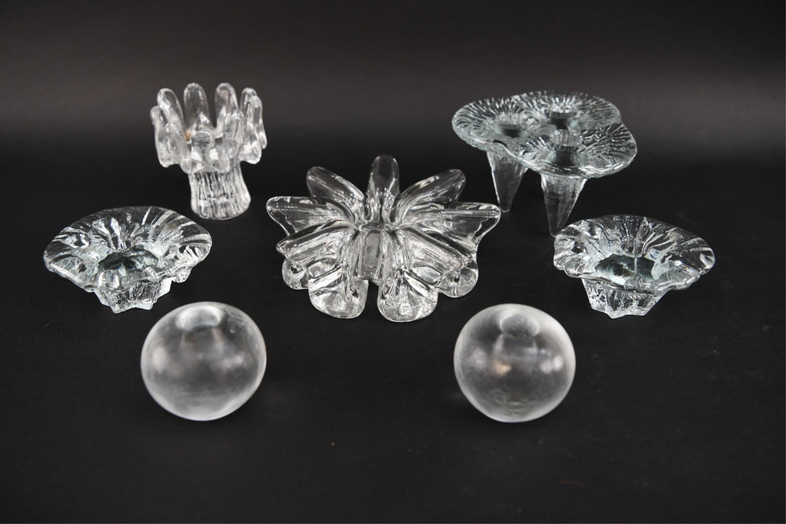 GROUPING OF SCANDINAVIAN ICE GLASS CANDLE HOLDERS: Spherical pair are signed on bottom. Dimensions: (Largest) H 2.25" x D 7.75" Condition: Showing light signs of use.