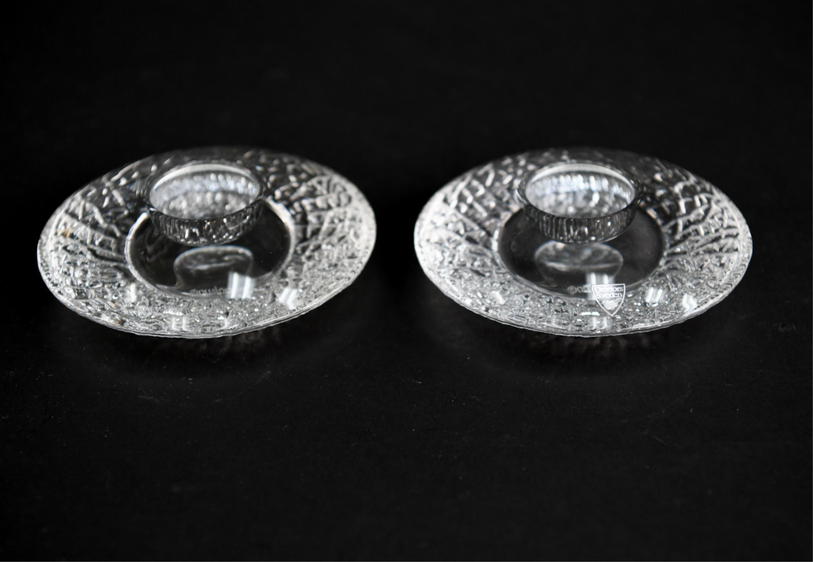 PAIR OF MID-CENTURY ORREFORS GLASS CANDLESTICKS: Marked on bases. Dimensions: H 1.75" x D 5.5" Condition: No issues to note.