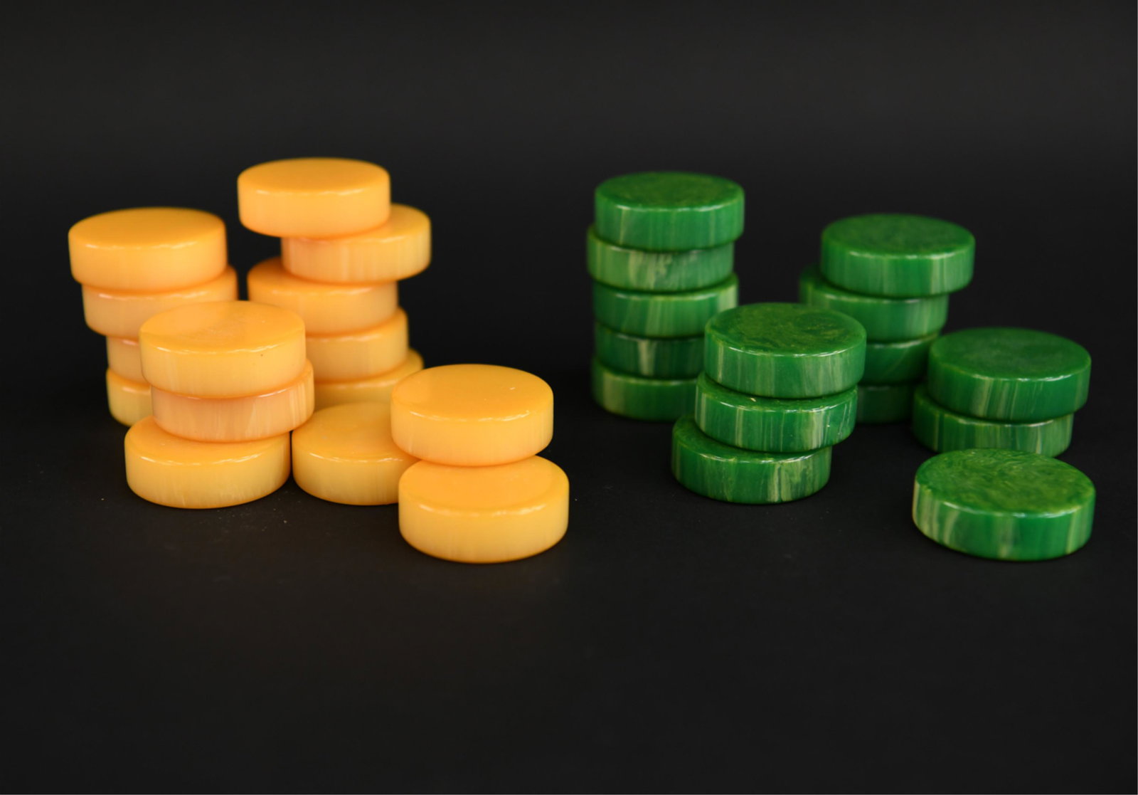 MID-CENTURY BAKELITE BACKGAMMON CHECKERS: Dimensions: (Per checker) D 1.5" Condition: Very light signs of use.