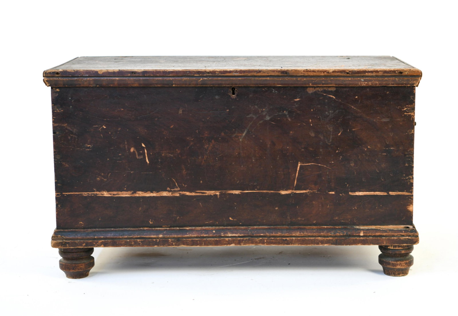 18th CENTURY DIMINUTIVE FOOTED CHEST: Dovetailed pine. Original hardware. Figured feet. Original brown surface. Dimensions: H 18" x W 31" x D 16" Condition: Wear consistent with age and use. Damages to hinges.