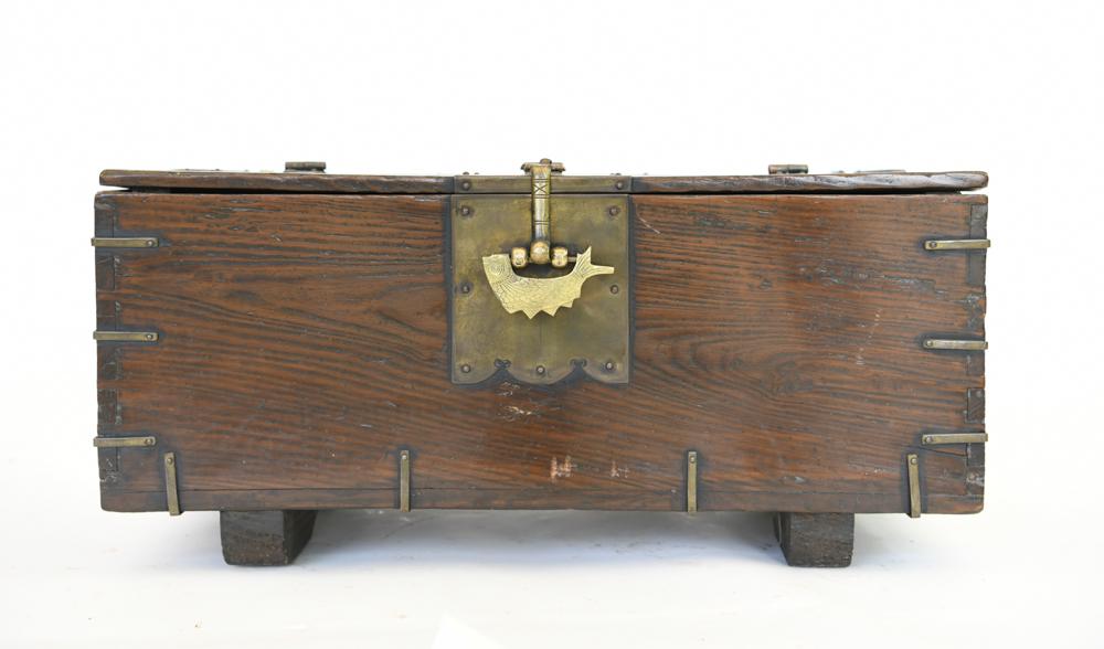 ANTIQUE KOREAN BRASS BANDED CHEST: Added feet. New lock. Dimensions: H 11" x W 24" x D 12.5" Condition: Well worn, aged surface. Few scratches to front.