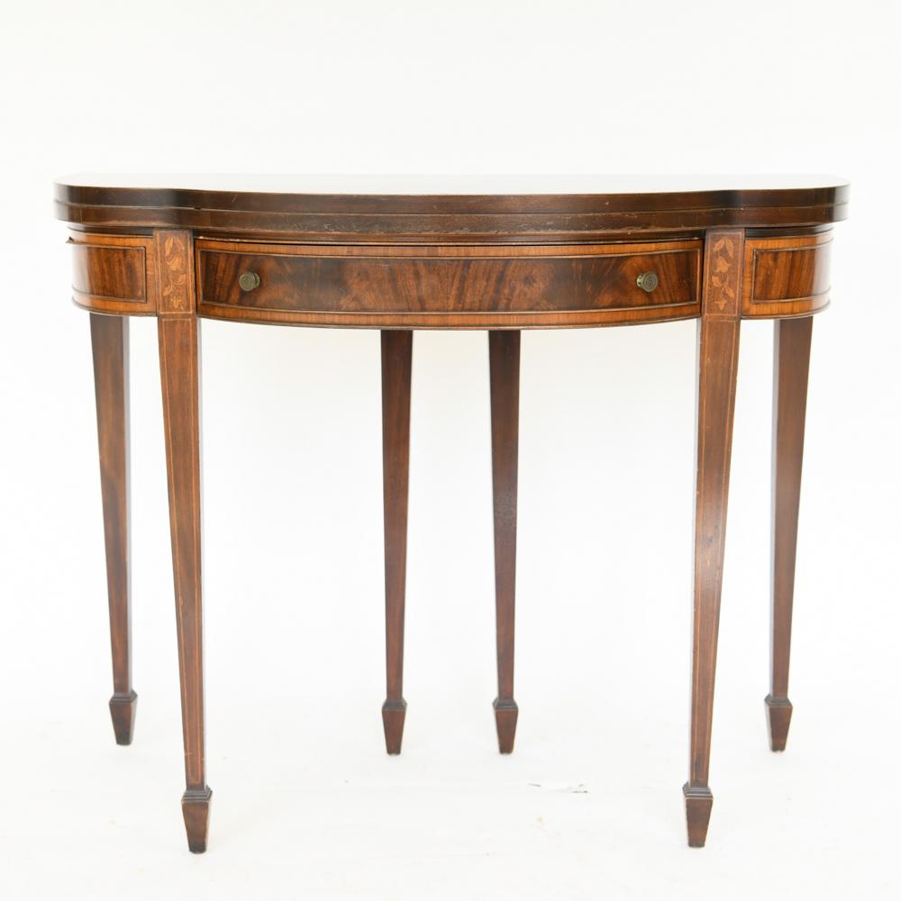 FEDERAL STYLE INLAID MAHOGANY GAMES TABLE: Early 20th century. Flame mahogany. Spade feet. Touches of inlay. Dimensions: H 30" x W 38.5" x D 38" Condition: Molding on proper right side coming detached. Surface scratches and wear.