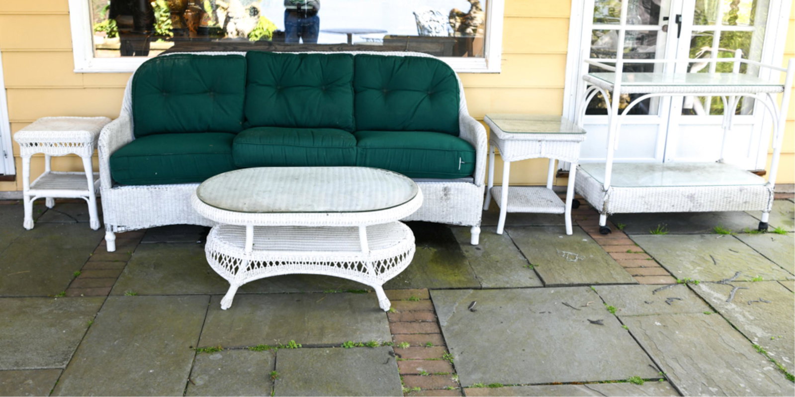 WICKER FURNITURE SUITE: Including bar cart. Dimensions: (Sofa) H 35" x W 76" x D 31" x SH 20" Condition: Sofa as-is, Showing wear consistent with normal outdoor use. Some small losses and breaks.