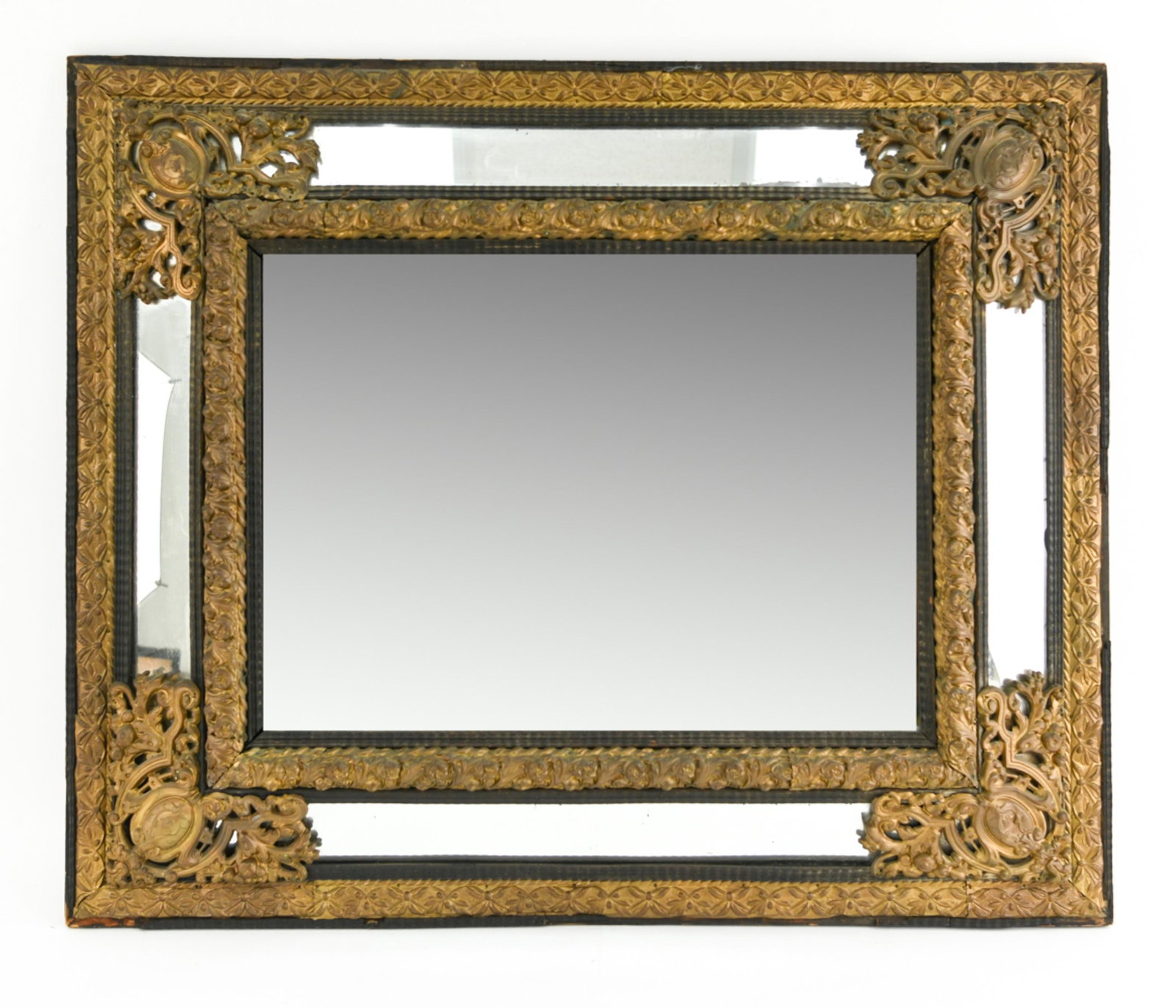 ANTIQUE SPANISH BAROQUE STYLE MIRROR: Beveled glass with presses brass overlay. Faux ebonized wood. Dimensions: H 34.5" x W 41.5" Condition: Some separation in the brass including some loose pieces. Rubbing on edges. Spotting behind glass