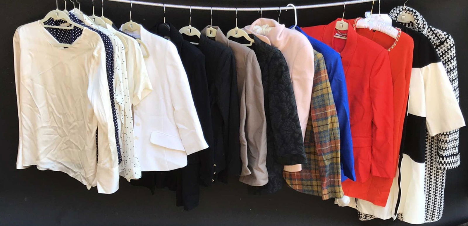 GROUPING OF LADIES DESIGNER TOPS: Including blouses, sweaters, and blazers. Names like Theory, Brooks Brothers, Tory Burch, Armani, Stella McCartney, etc. Sizes: 6, S, 42, 38. Condition: Showing light signs of use.