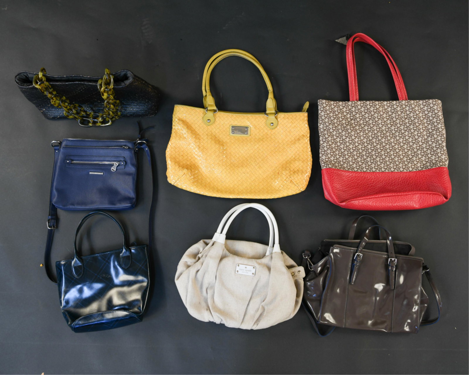 GROUPING OF DESIGNER HANDBAGS: Including: Kate Spade, Longchamp, Silvano Viagni, Dana Buchman, DKNY, Innue. Condition: Used, showing signs of use.