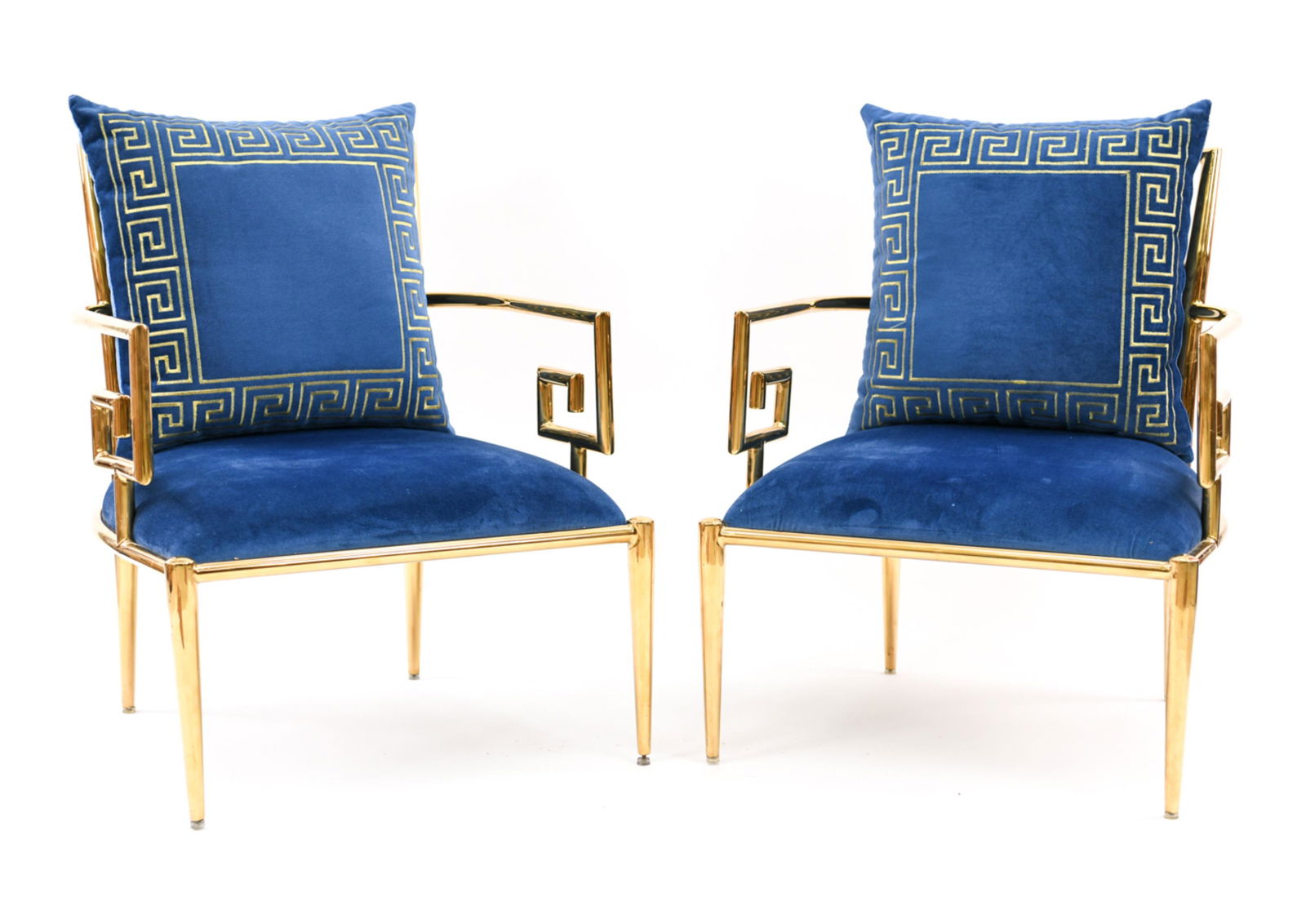 MASTERCRAFT BRASS GREEK KEY LOUNGE CHAIRS: A striking pair of brass and blue velvet chairs with Greek keys motif on both the chairs and the velvet upholstered and embroidered pillow. Mid-Century. Dimensions: H 33" x W 26" x D 28" x SH 15" Cond