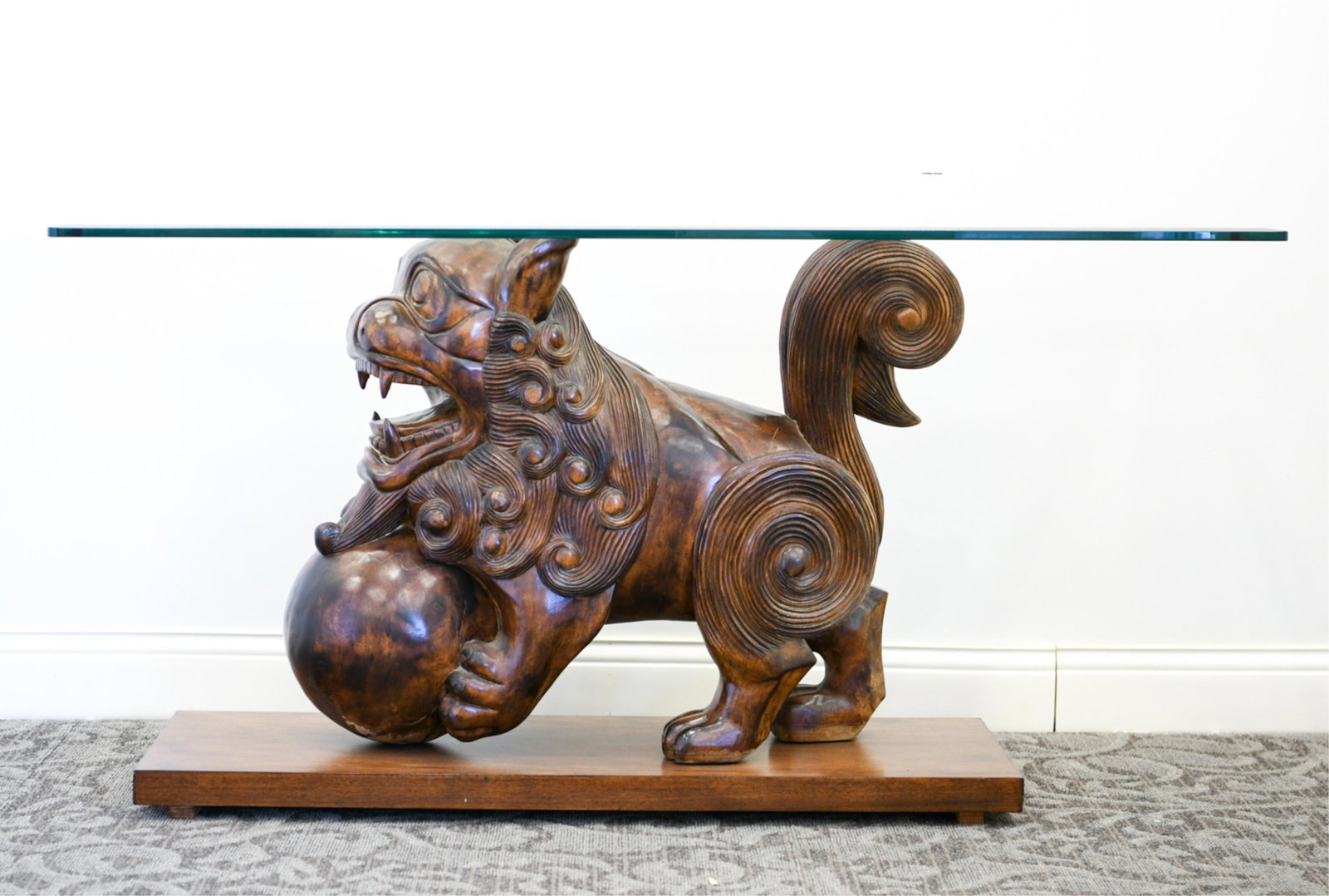 CARVED WOODEN FOO DOG LION CONSOLE TABLE: Dimensions: Base: H 28.5" x W 43.5" x D 16" Top: L 60" x W 18" x D 0.50" Condition: Showing minor signs of age.