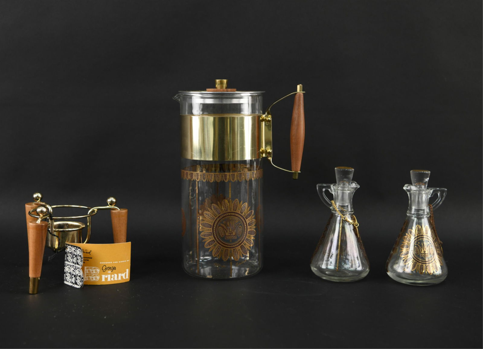 GEORGES BRIARD COFFEE CARAFE AND CRUETS: Marked Briard. With original hang tags on oil and vinegar. Dimensions: (Carafe) H 10" x W 6.5" Condition: Minor signs of age.
