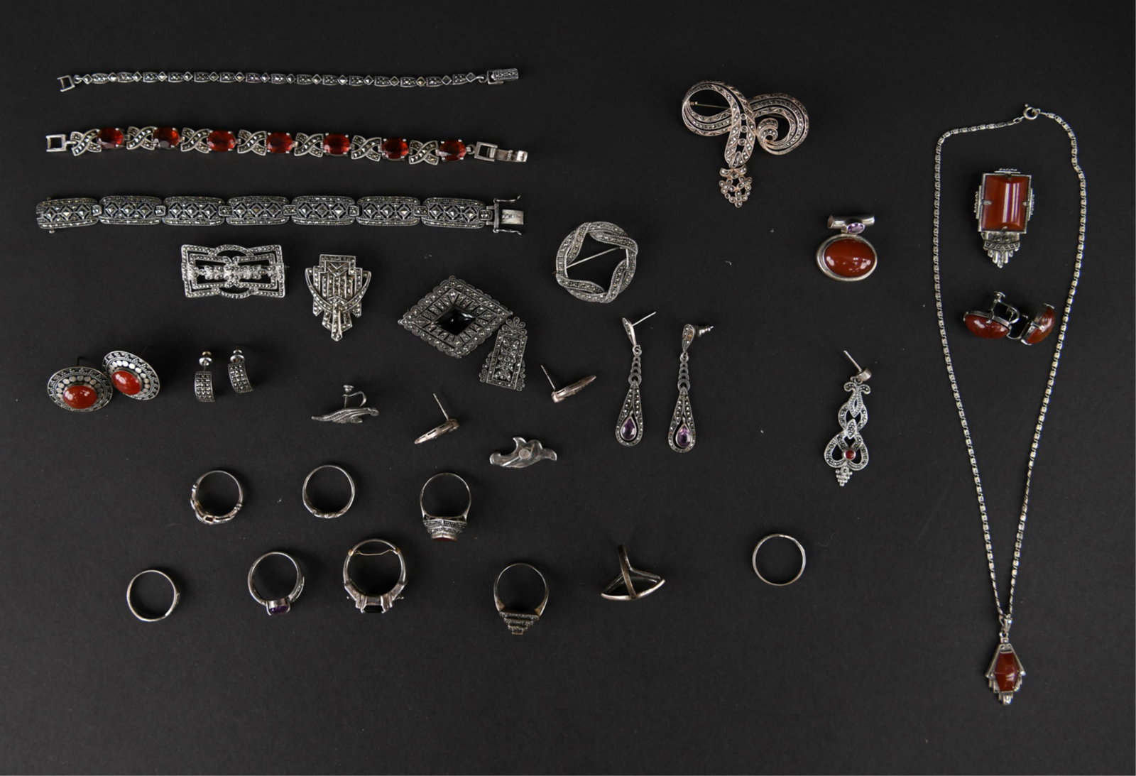 STERLING AND MARCASITE JEWELRY GROUPING: Large grouping of sterling silver and marcasite jewelry, also including some garnet and agate. Dimensions: Bracelet: L 7.5" x W 0.25" Weight: 6.16 ozt Condition: Showing light signs of age, wearable.