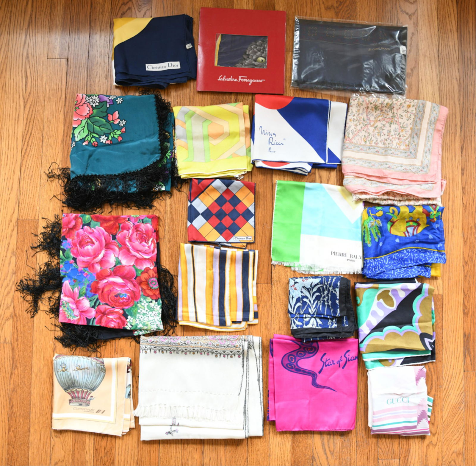 LARGE GROUPING OF DESIGNER SCARVES: Including Gucci, Nina Ricci, Ferragamo, Christian Dior, etc. Condition: Used, showing light signs of use and minimal staining.