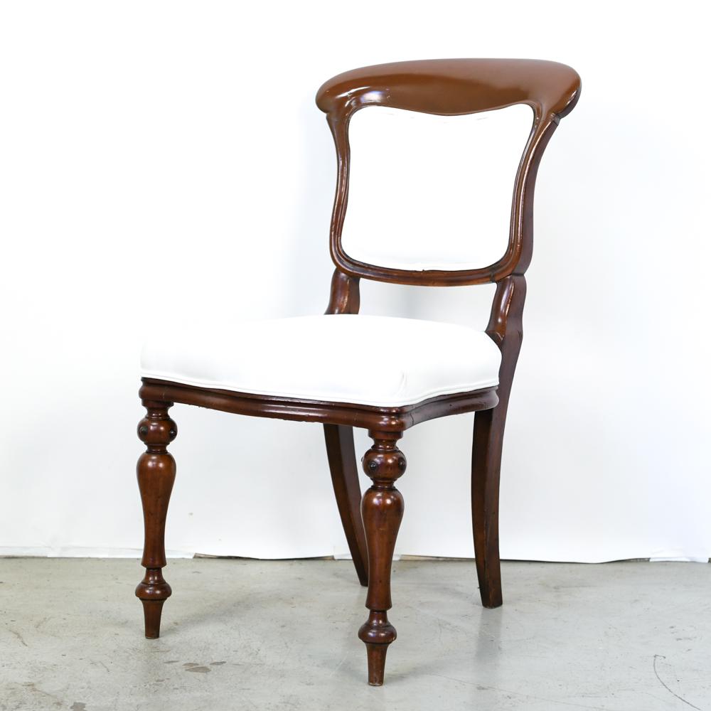 19TH C. ENGLISH SIDE CHAIR: With serpentine front, curved back, and turned legs. Restored and reupholstered in white muslin. Dimensions: H 34" x W 18.25" x D 18.5" x SH 18" Condition: Few very minor handling marks to upholstery.