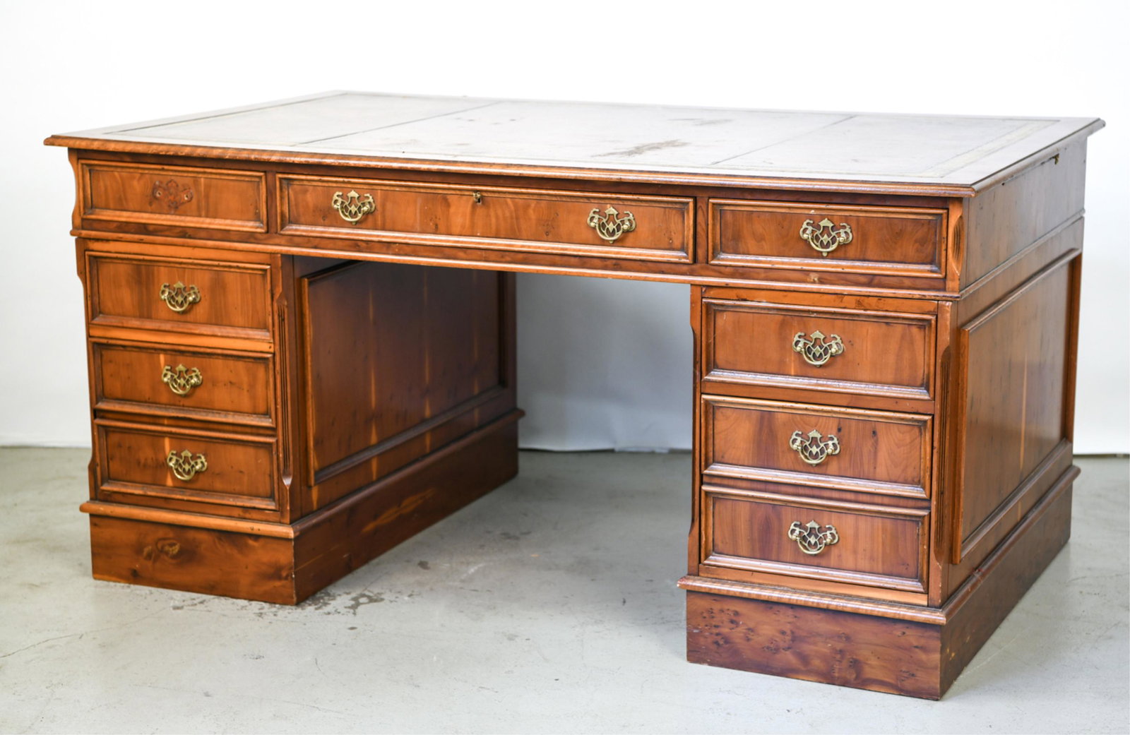 ENGLISH LEATHER TOP FAUX PARTNERS DESK: Marked "Made in England" on base. Separates into three pieces. Drawers only open from one side. Dimensions: H 30" x W 60.5" x D 37" Condition: Missing one pull from front, pull out writing surface als