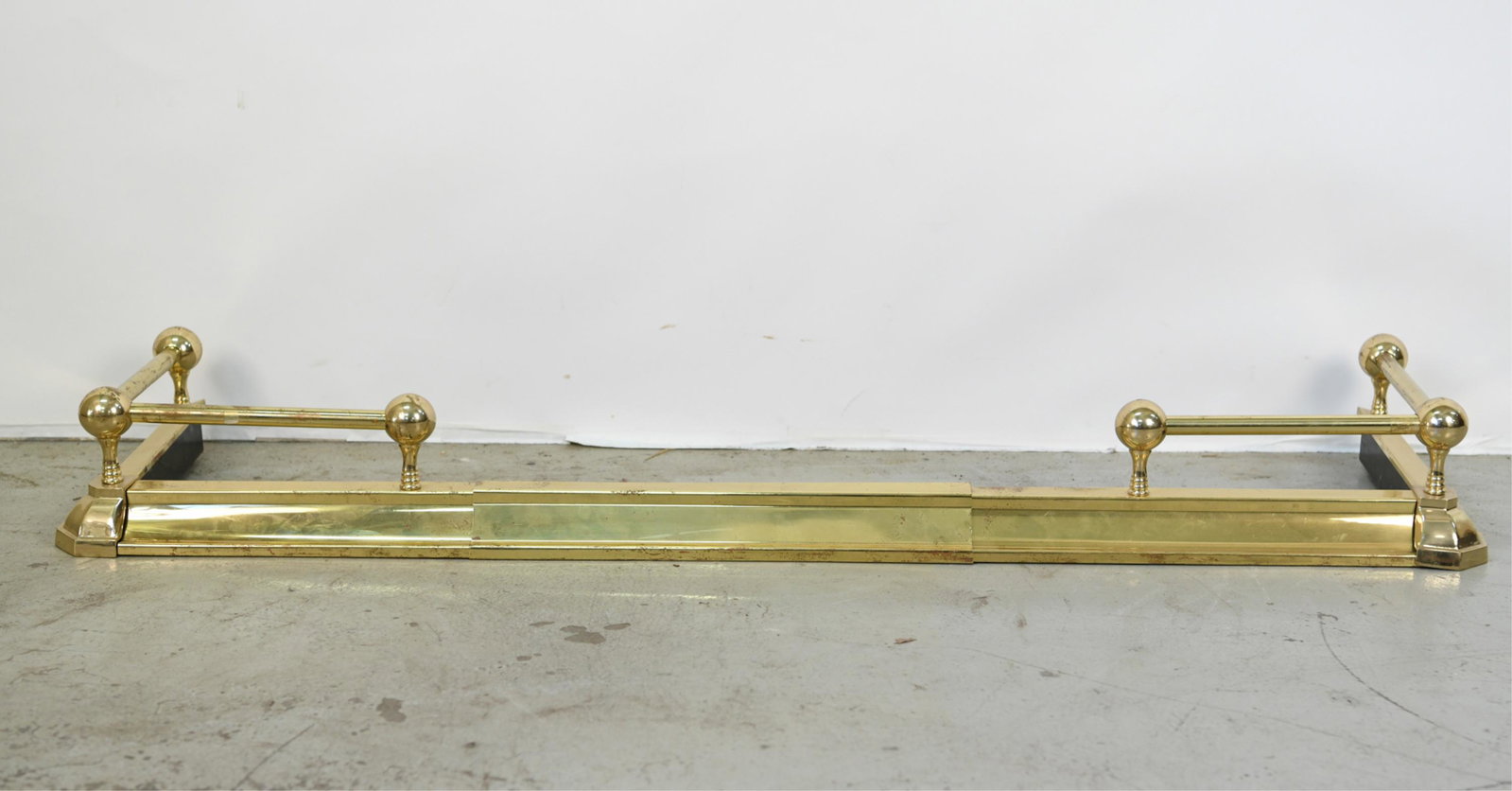 CONTEMPORARY BRASS EXTENDING FIRE FENDER: Dimensions: (Smallest) H 6" x W 54" x D 15" Condition: Some pitting, tarnishing, denting.
